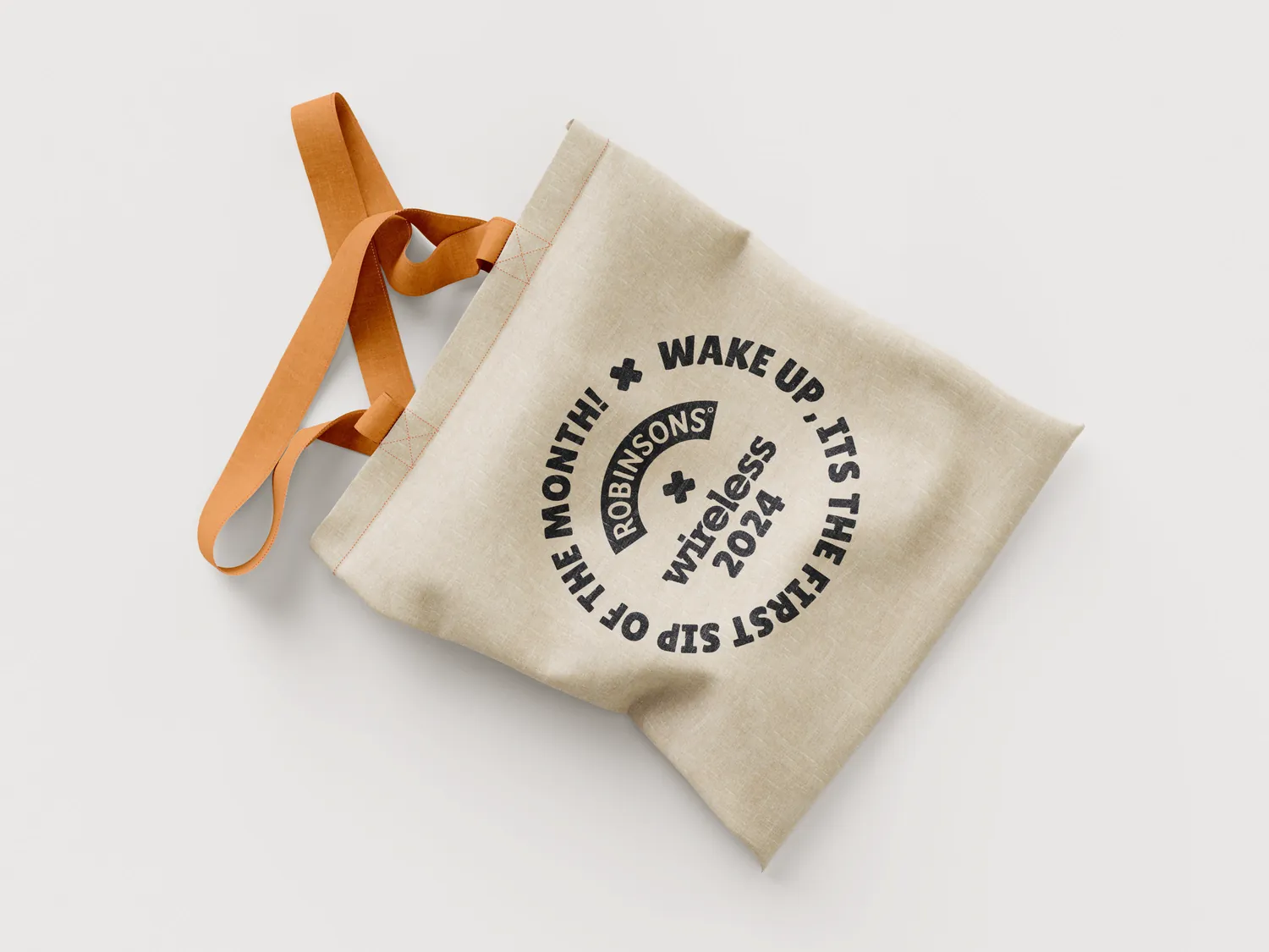 A canvas tote bag printed with the Robinsons x wireless roundel