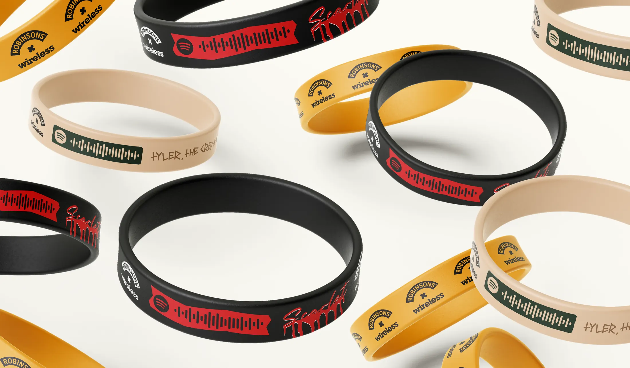 Festival wristbands in black, yellow and sand, printed with artist names